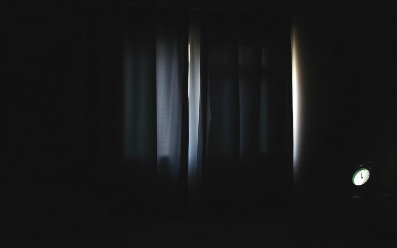 Blackout bedroom during daylight hours with an alarm clock